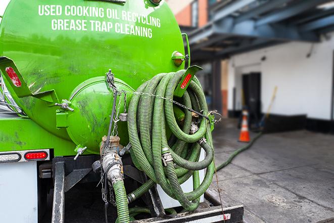 a grease trap pumping truck at a restaurant in Circle Pines